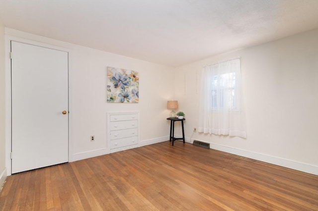 spare room with hardwood / wood-style floors