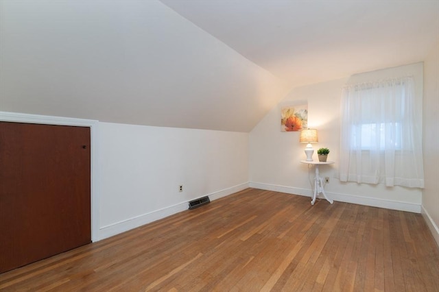 bonus room featuring vaulted ceiling and wood-type flooring