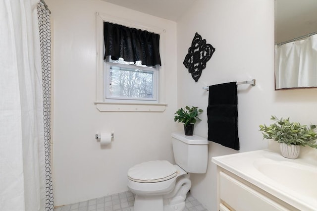 bathroom featuring vanity and toilet