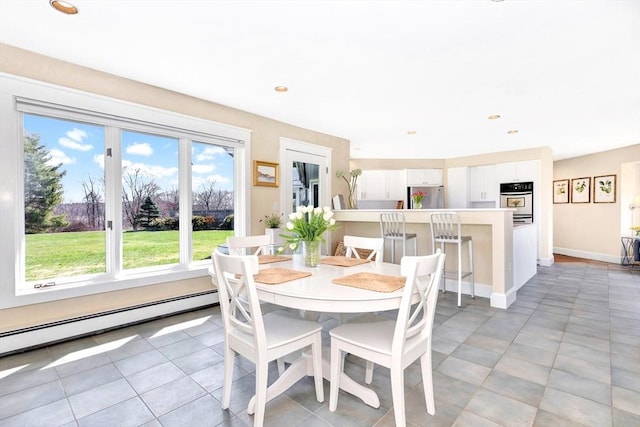 dining space with baseboards and baseboard heating