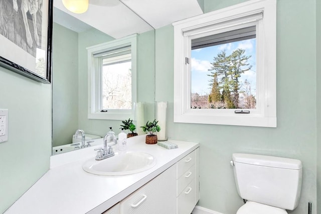 half bathroom with vanity and toilet