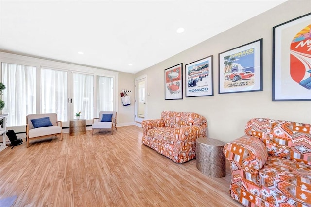 living area with light wood-type flooring and recessed lighting