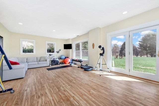 workout room with baseboards, recessed lighting, and wood finished floors