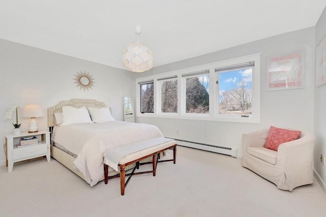 bedroom with light colored carpet, baseboards, and a baseboard heating unit