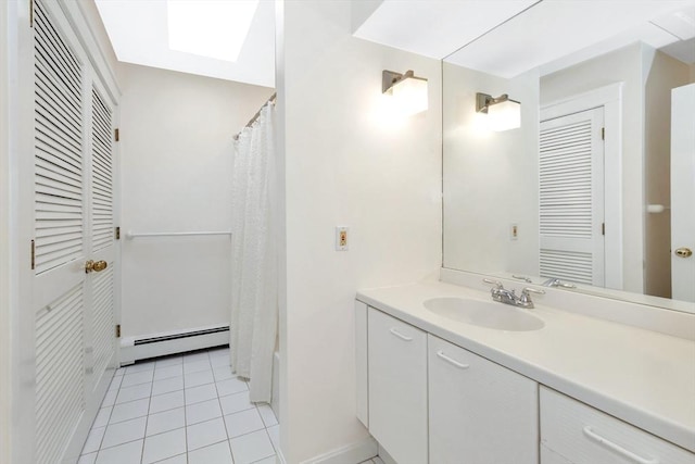 bathroom with tile patterned floors, a baseboard heating unit, curtained shower, and vanity