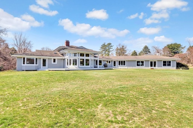 back of property featuring a yard and a chimney