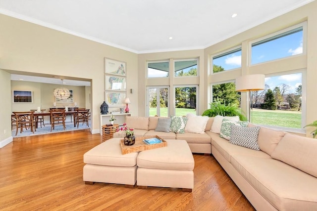 living area with crown molding, recessed lighting, baseboards, and light wood-type flooring