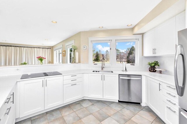 kitchen featuring a sink, light countertops, stainless steel appliances, recessed lighting, and white cabinetry