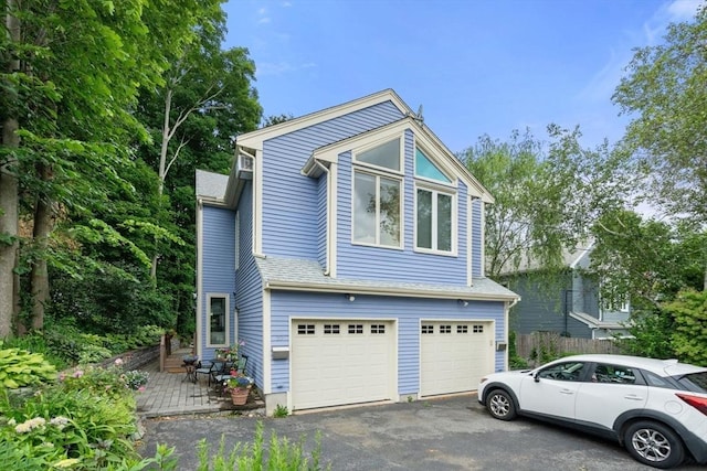 27 5th Ave Unit 27, Watertown, MA 02472 - view of front of house featuring an attached garage and asphalt driveway