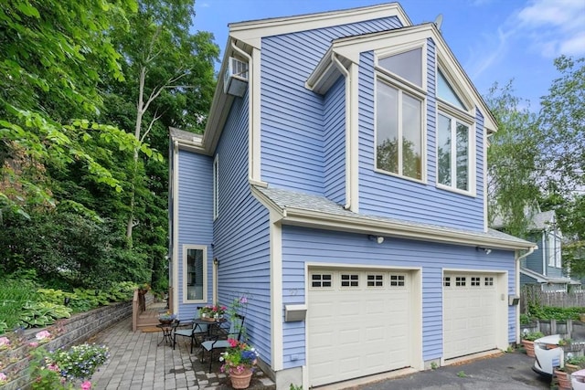 27 5th Ave Unit 27, Watertown, MA 02472 - view of side of home featuring an attached garage and driveway