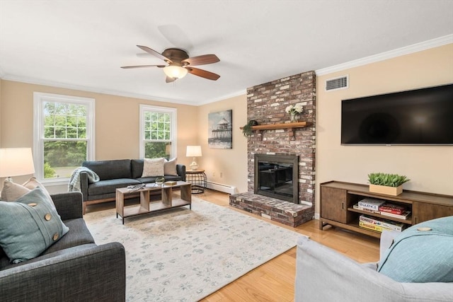 6 Magnolia Cir, Norfolk, MA 02056 - living area with a baseboard radiator, ornamental molding, a ceiling fan, wood finished floors, and a brick fireplace