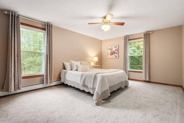 6 Magnolia Cir, Norfolk, MA 02056 - carpeted bedroom featuring multiple windows, a baseboard heating unit, and ceiling fan