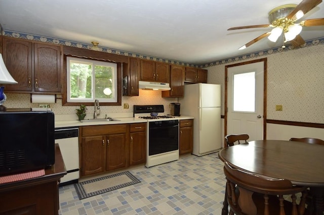 kitchen featuring ceiling fan, sink, and white appliances