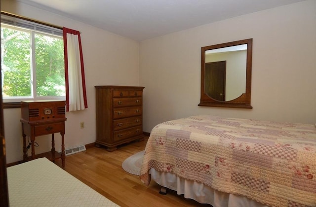 bedroom with hardwood / wood-style floors