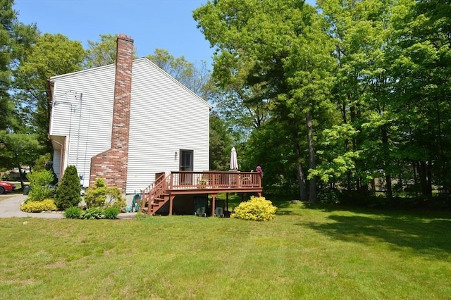 back of house with a yard and a wooden deck