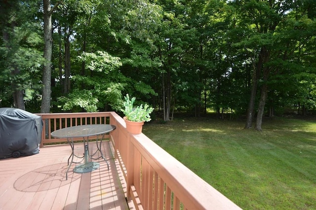 wooden deck with a lawn and grilling area