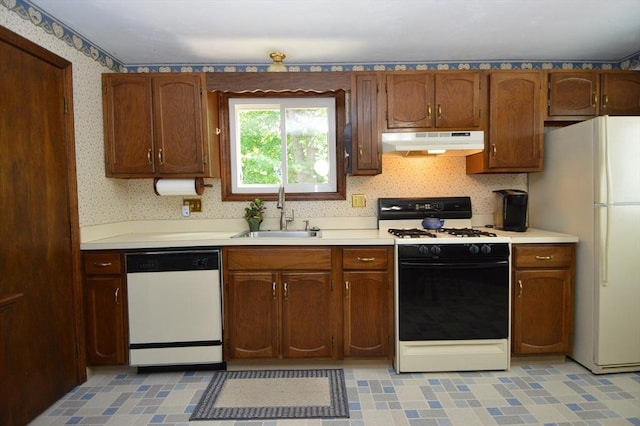 kitchen featuring white appliances and sink