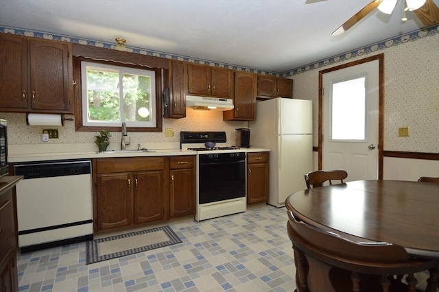 kitchen featuring ceiling fan, sink, and white appliances