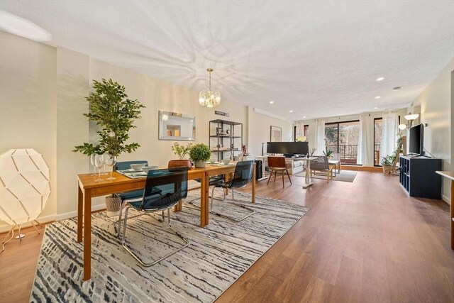 dining room featuring recessed lighting, a chandelier, baseboards, and wood finished floors