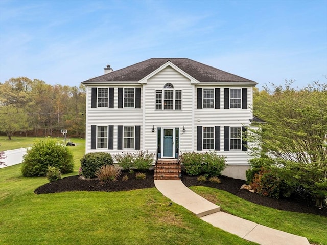42 Britton St, Raynham, MA 02767 - colonial home featuring a front yard and a chimney