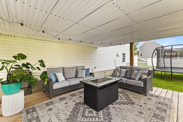 42 Britton St, Raynham, MA 02767 - view of patio / terrace with an outdoor living space, a trampoline, a wooden deck, and fence