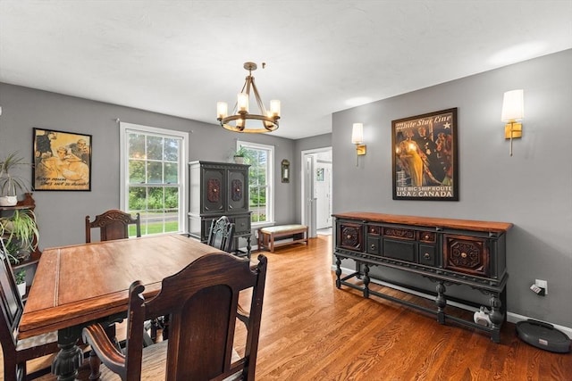42 Britton St, Raynham, MA 02767 - dining area featuring a chandelier, wood finished floors, and baseboards