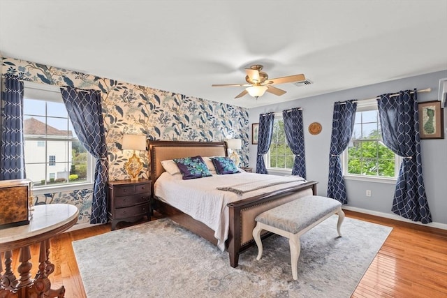42 Britton St, Raynham, MA 02767 - bedroom featuring wallpapered walls, baseboards, wood finished floors, an accent wall, and ceiling fan