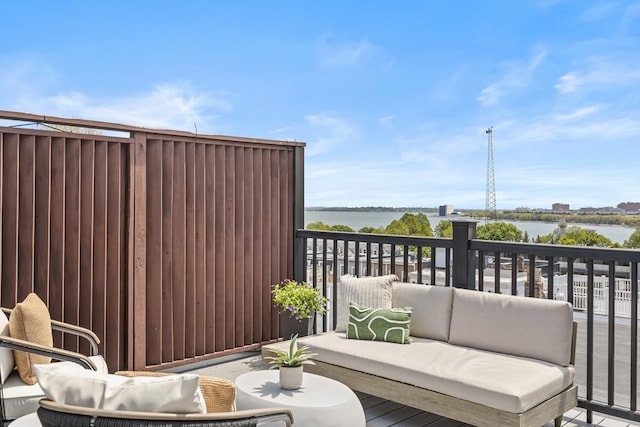 deck featuring an outdoor hangout area and a water view