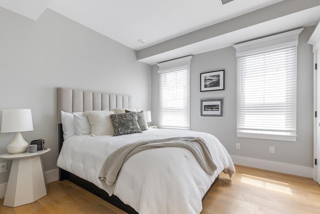 bedroom featuring light wood-style floors and baseboards