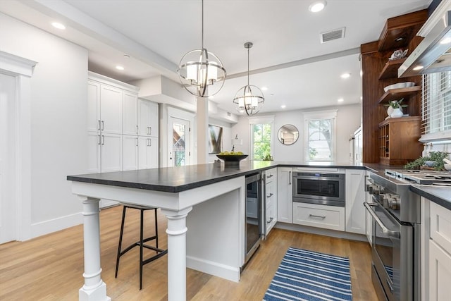 kitchen featuring high end stove, wall chimney exhaust hood, dark countertops, open shelves, and white cabinetry