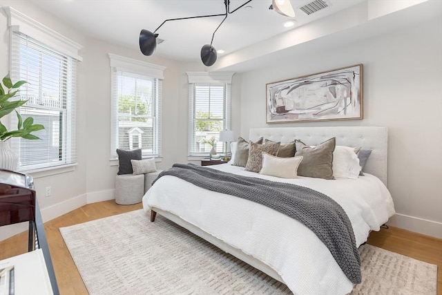 bedroom with baseboards and wood finished floors