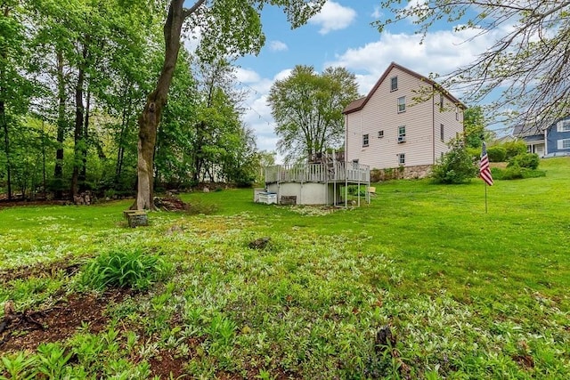 view of grassy yard featuring a wooden deck