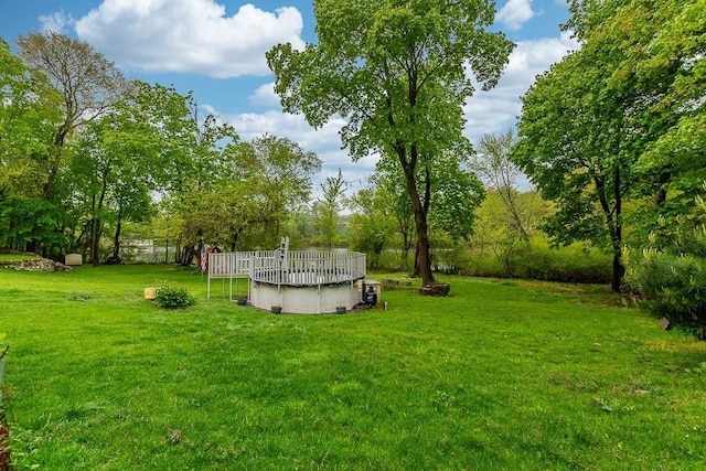 view of grassy yard featuring a covered pool