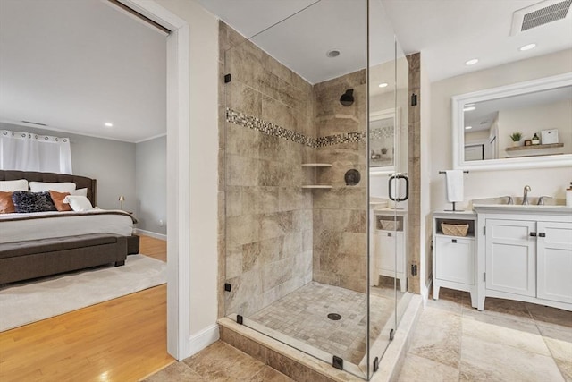 bathroom with visible vents, a shower stall, vanity, baseboards, and recessed lighting