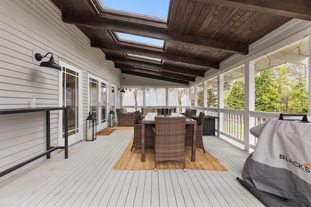 wooden deck featuring outdoor dining area