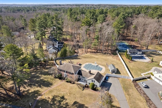 birds eye view of property featuring a wooded view
