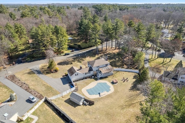 drone / aerial view with a wooded view