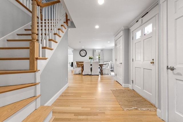 entrance foyer with recessed lighting, baseboards, stairs, and wood finished floors