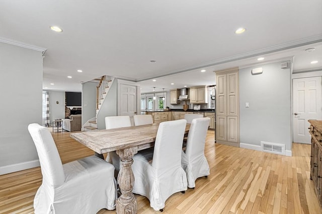dining room featuring visible vents, crown molding, stairway, baseboards, and recessed lighting
