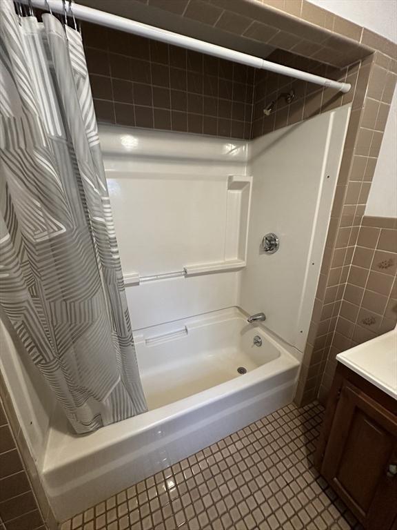 50 Keene St, Lowell, MA 01852 - bathroom featuring shower / tub combo with curtain, vanity, tile walls, and tile patterned floors