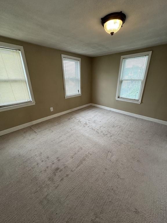 50 Keene St, Lowell, MA 01852 - spare room featuring healthy amount of natural light and carpet floors