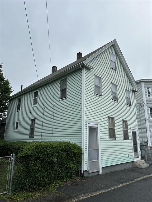 50 Keene St, Lowell, MA 01852 - view of home's exterior with a chimney
