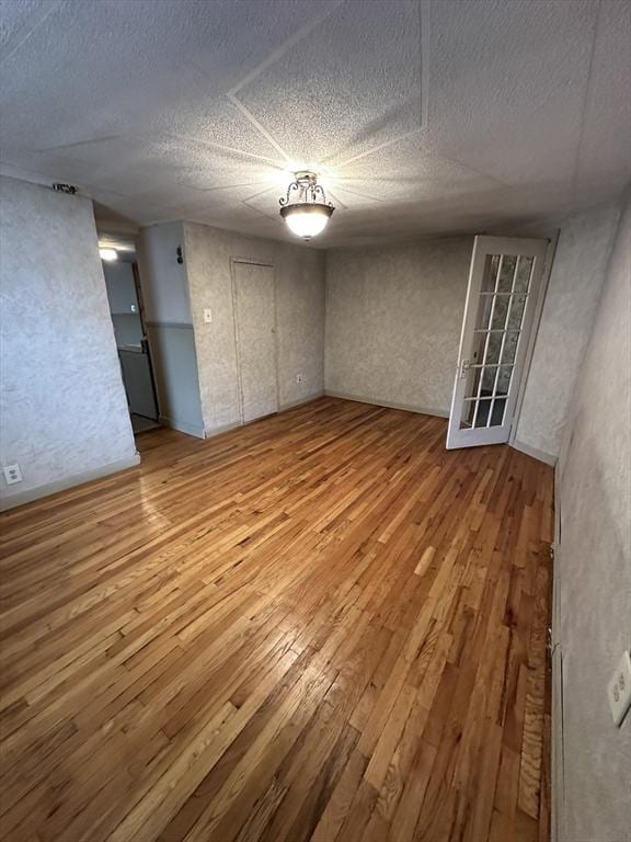 50 Keene St, Lowell, MA 01852 - empty room featuring hardwood / wood-style floors and a textured ceiling