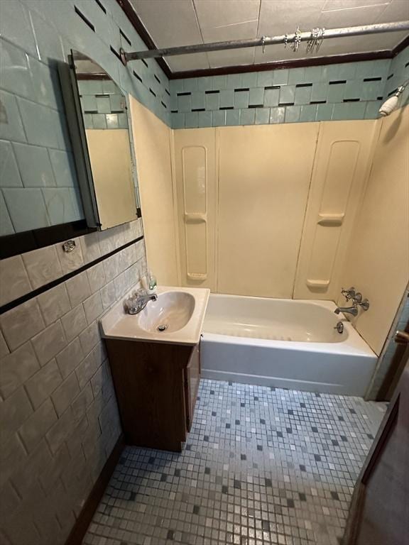 50 Keene St, Lowell, MA 01852 - full bath featuring vanity, shower / tub combination, tile patterned flooring, and tile walls