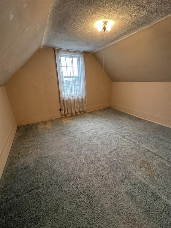 50 Keene St, Lowell, MA 01852 - bonus room with lofted ceiling, a textured ceiling, and carpet floors