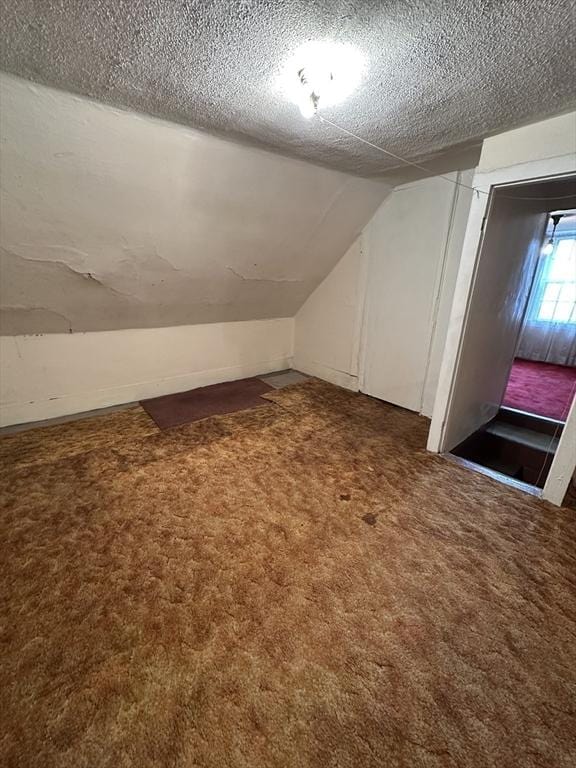 50 Keene St, Lowell, MA 01852 - bonus room with carpet, lofted ceiling, and a textured ceiling