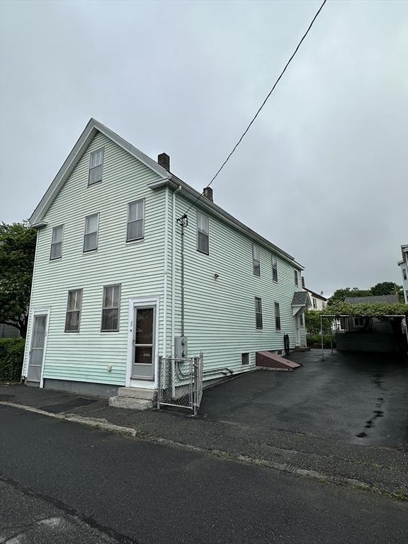 50 Keene St, Lowell, MA 01852 - view of side of property with a chimney