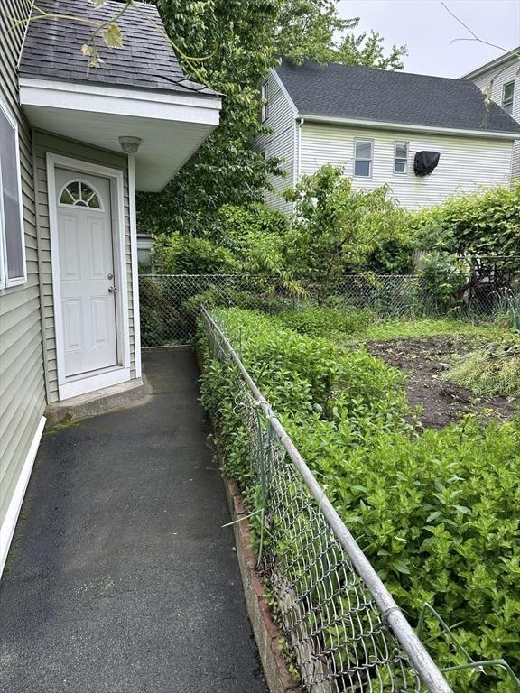 50 Keene St, Lowell, MA 01852 - doorway to property featuring a shingled roof