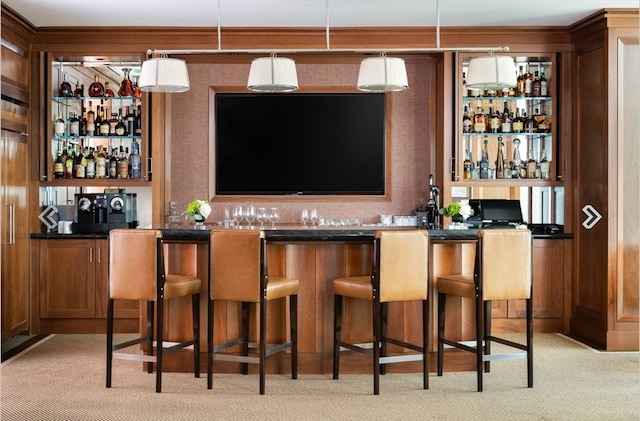 bar featuring light colored carpet and hanging light fixtures