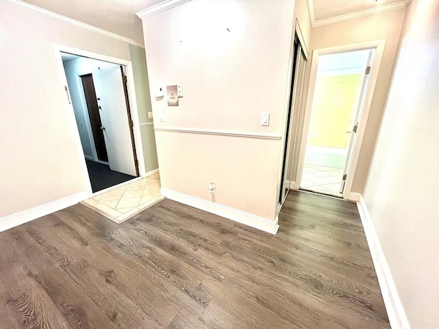 empty room with hardwood / wood-style floors and ornamental molding